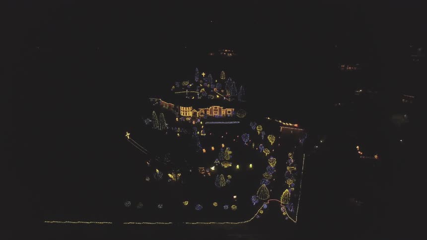 An aerial view of a house lit up for the holiday season