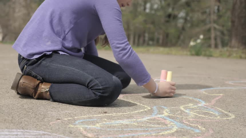 Children are playing with chalk outdoors