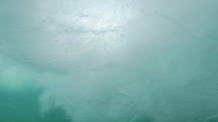 Epic underwater view of a wave crashing onto the surface of the ocean