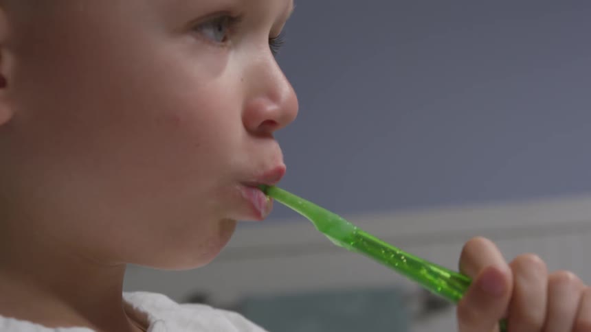 A child brushes his teeth
