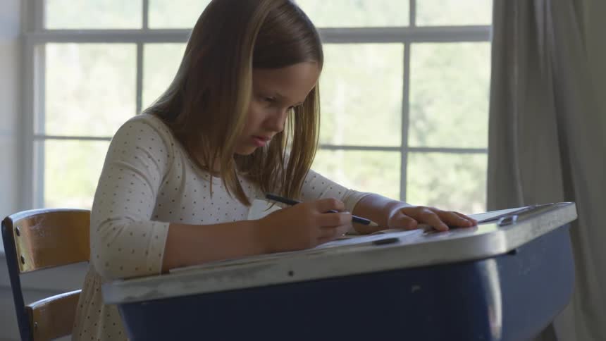 Girl sitting at desk writing