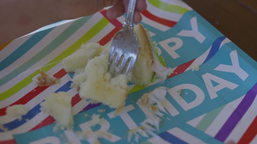 A person puts a fork in to a piece of cake