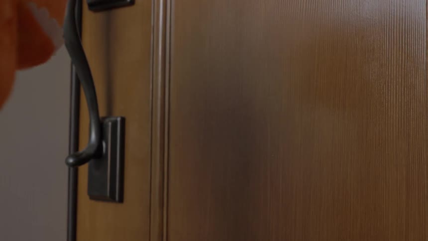 Child wearing halloween costume knocks a door in the daytime