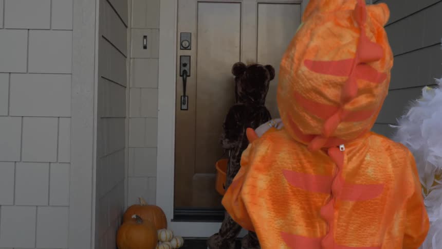 Children in costumes knock on doors for trick or treating