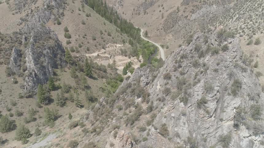 Landscape of mountains and big rock with valley road in the daytime