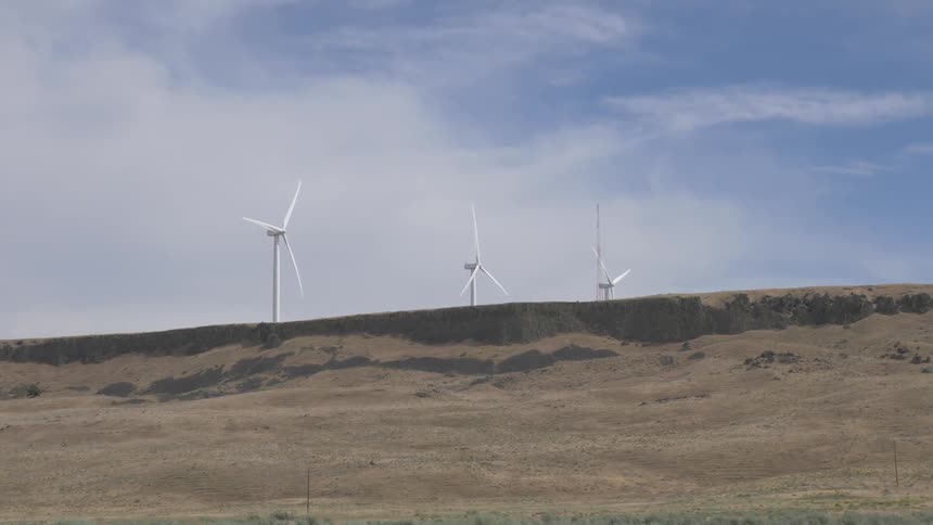 Wind turbines on ridge near sand
