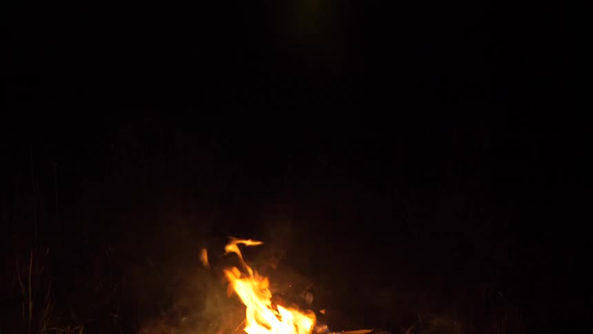 Campfire burns in the night