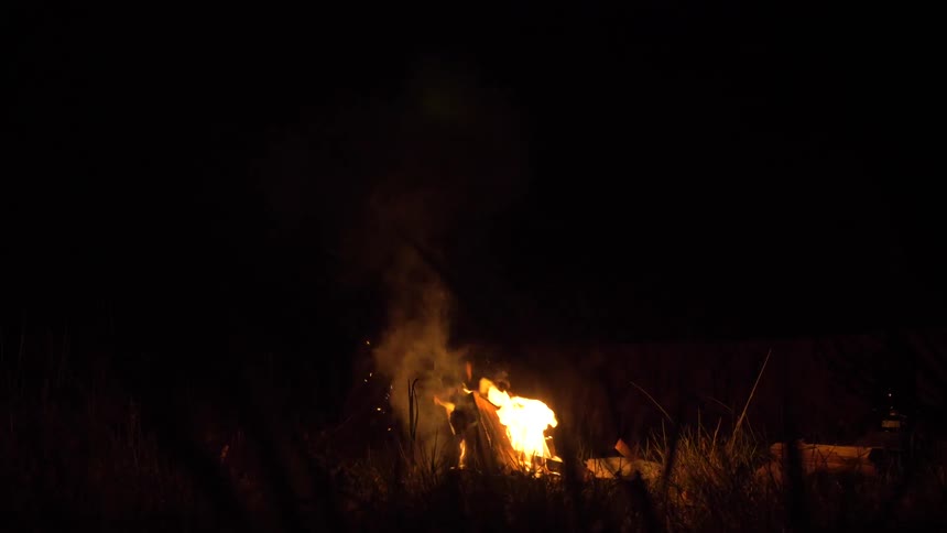 A fire burns at night
