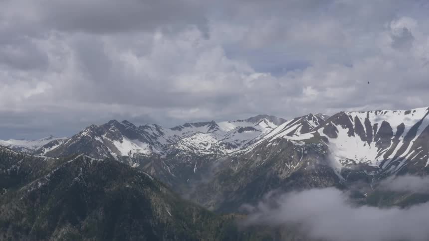 Dark clouds float over a mountain range