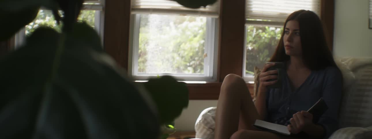 Woman reads a book and holds a mug