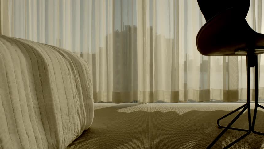 A chair in front of a bed