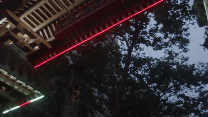 The camera looks up at a lit arch