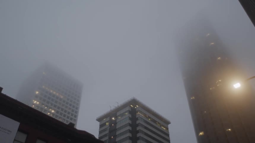 Morning fog covers up top of skyscrapers