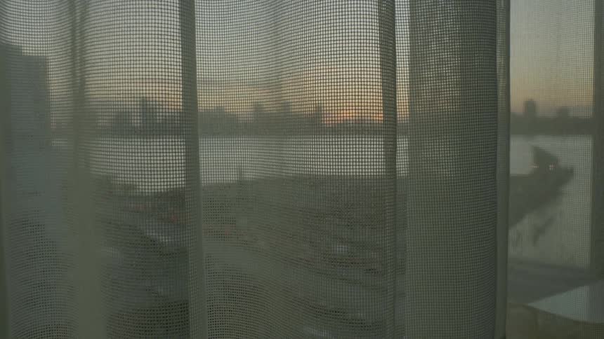 A view out of a window of a city and waterway