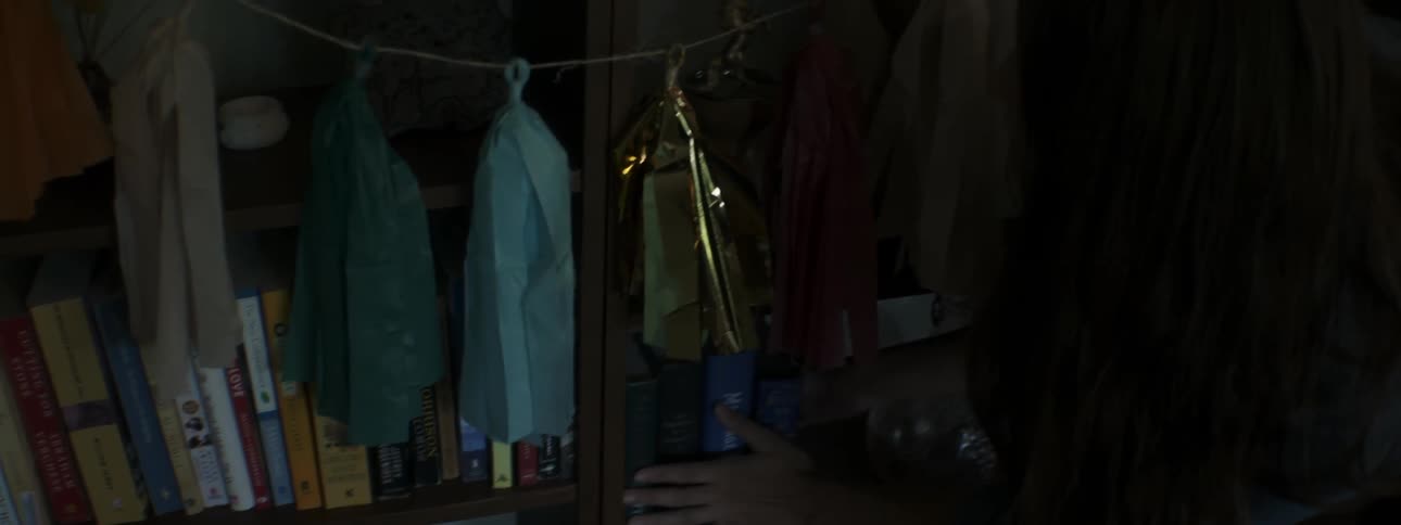 Woman puts a book back on a shelf