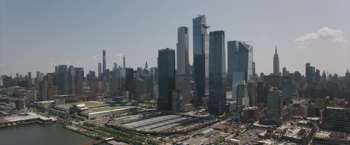 Skyline of the city with tall skyscrapers next to the sea during daylight
