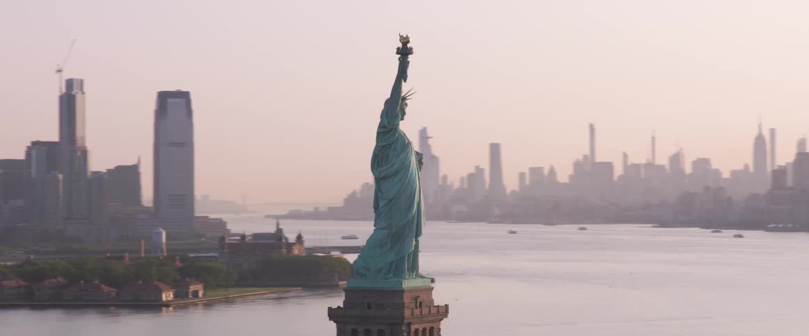 An aerial orbiting shot of the statue of liberty