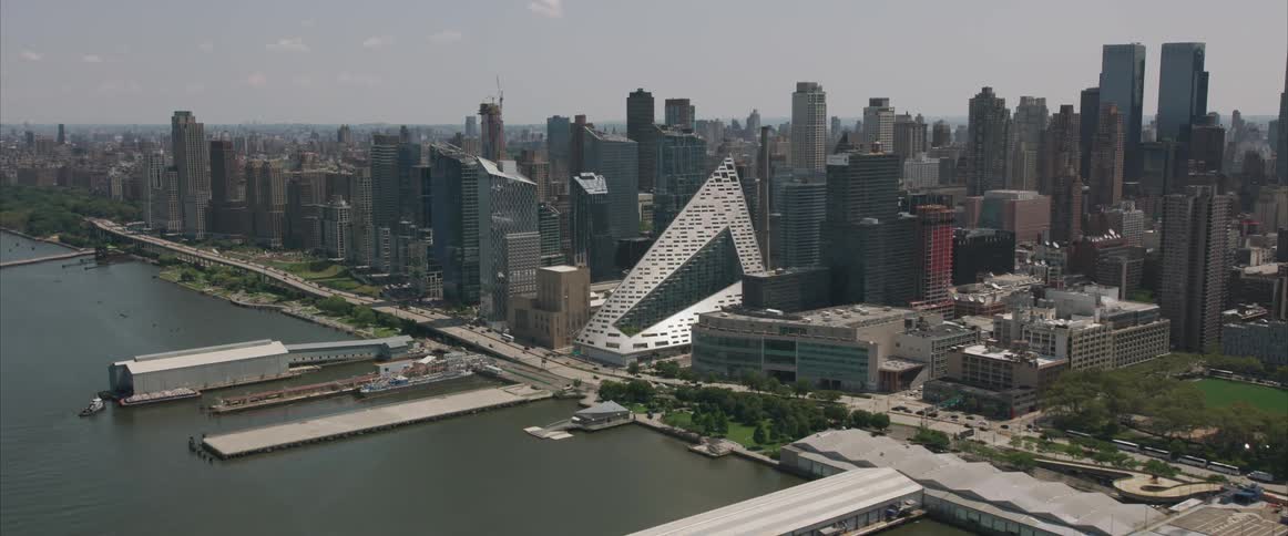 A marina along a river in a dense metropolis