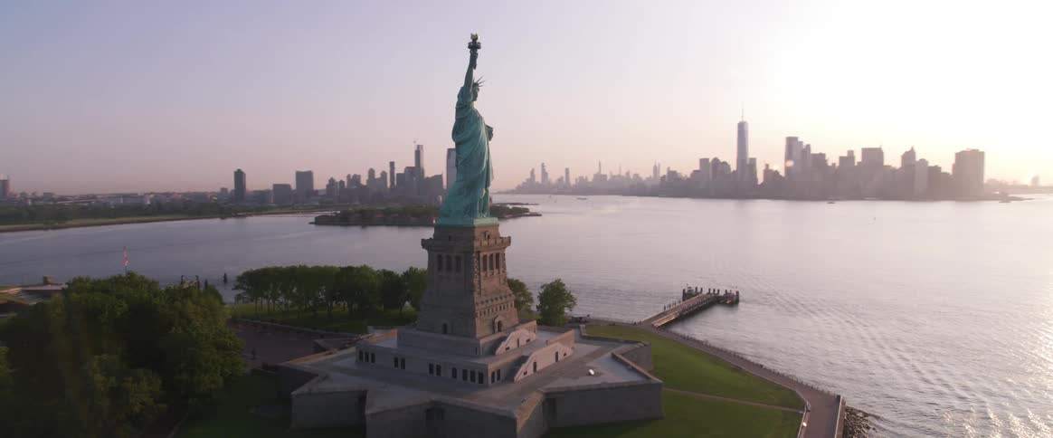 Skyline view of the statue of liberty in front