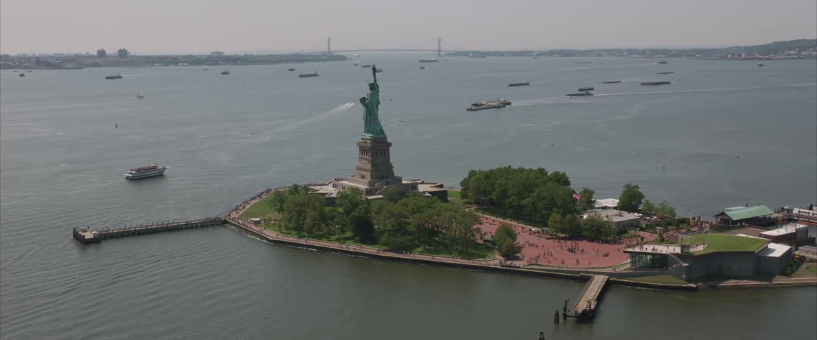 The statue of liberty stands tall on an island in new york city