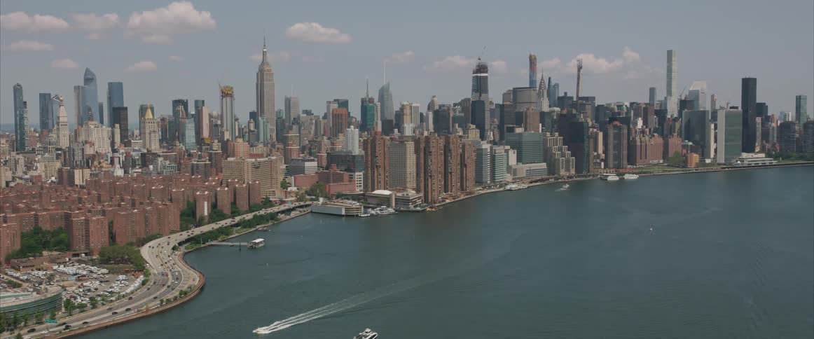 Boats traveling the coast next to a large city