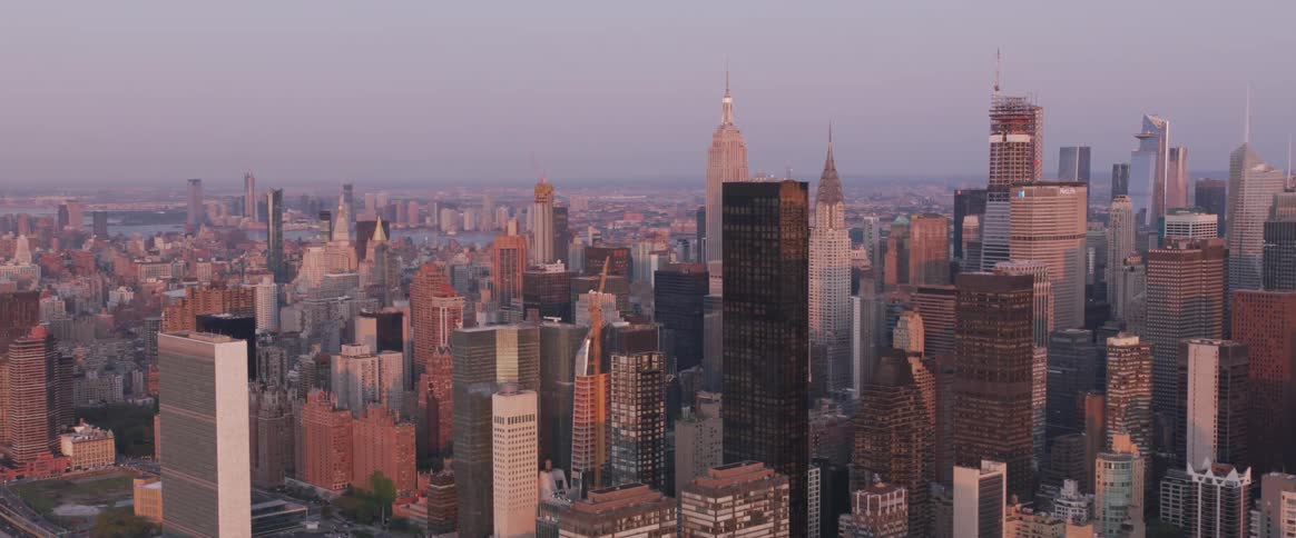 The camera flies next to a metro city and river