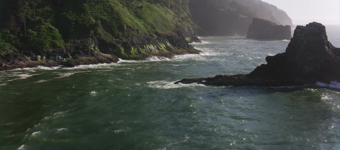 Waves crash against a rocky shoreline