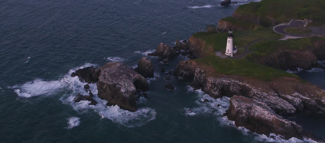 A lighthouse standing along a rocky cliff