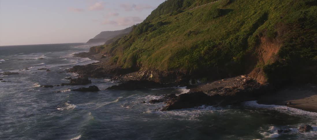 Small waves crashing up to a rocky shore line