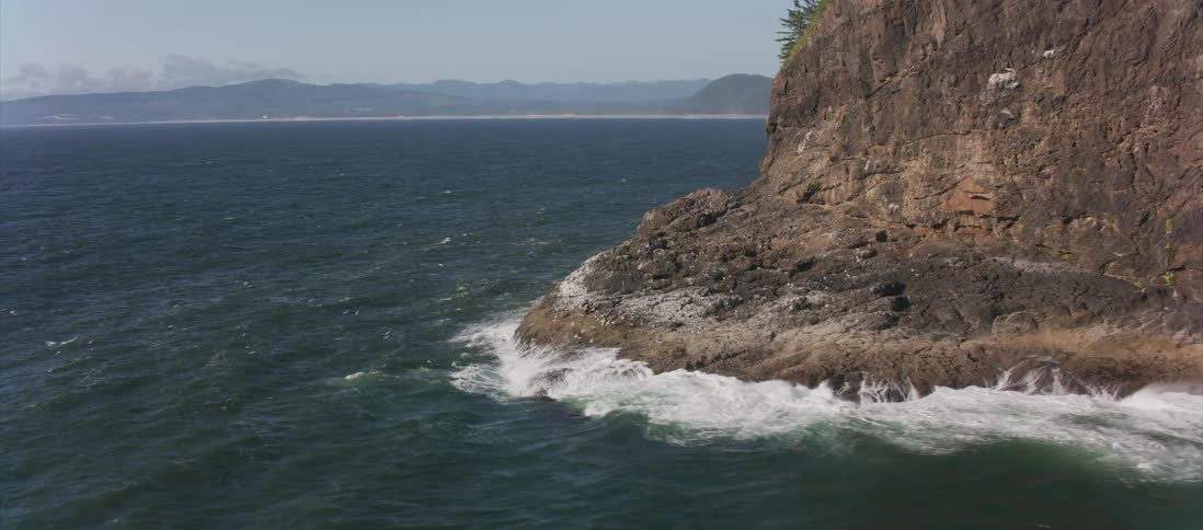 Waves crashing in to a cliff