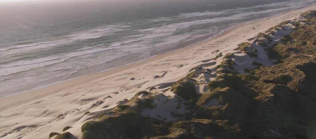 Small waves meet a beach