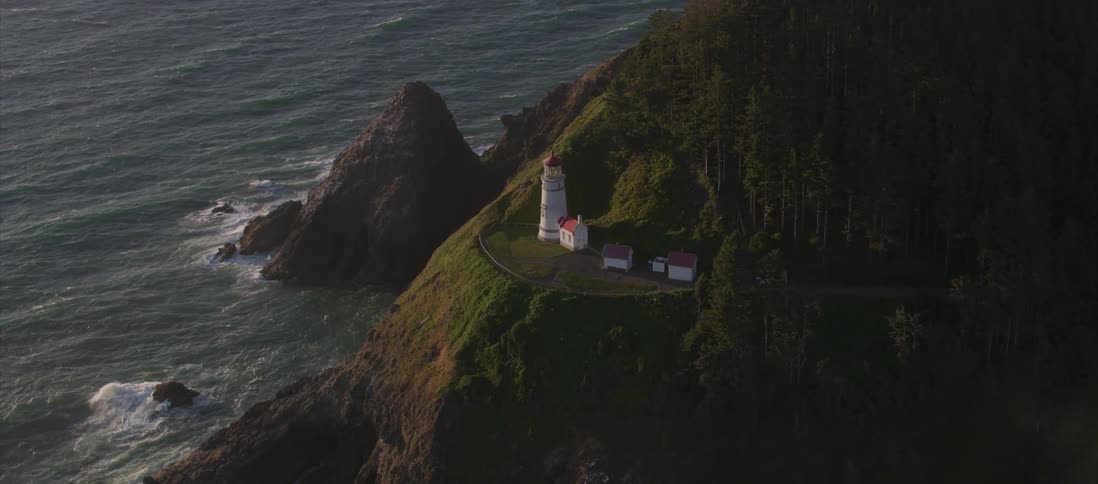 Aerial view of a lighthouse on the cliffs of a coast