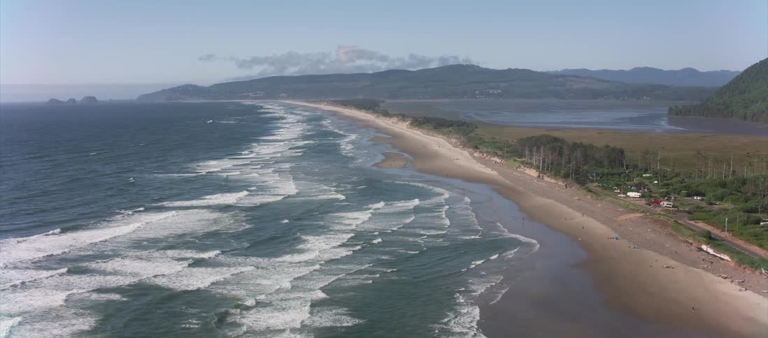 Ocean waves crash into a coastal shoreline