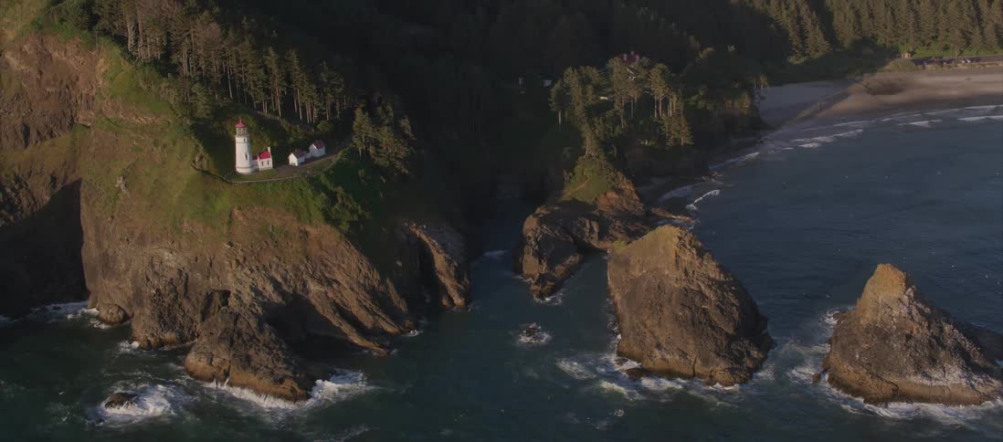 Aerial view of a lighthouse on the cliffs of the coast