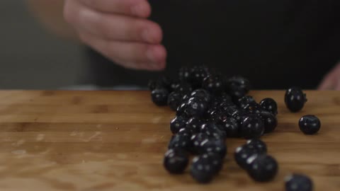 Blueberries are scooped off of a counter
