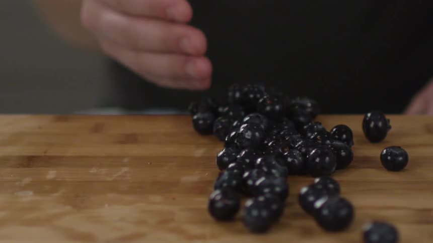Blueberries are scooped off of a counter