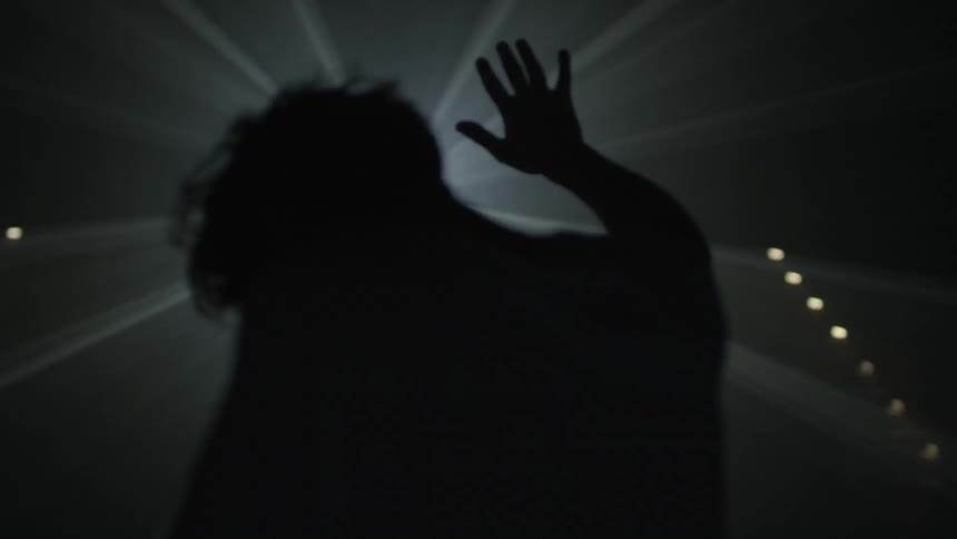 Man shields eyes with hand