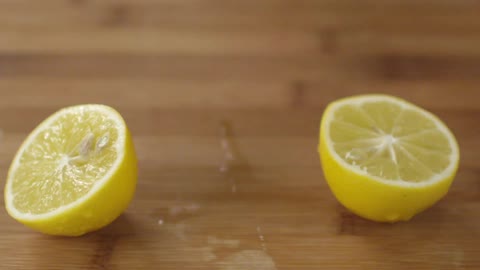 A knife slices a lemon in two