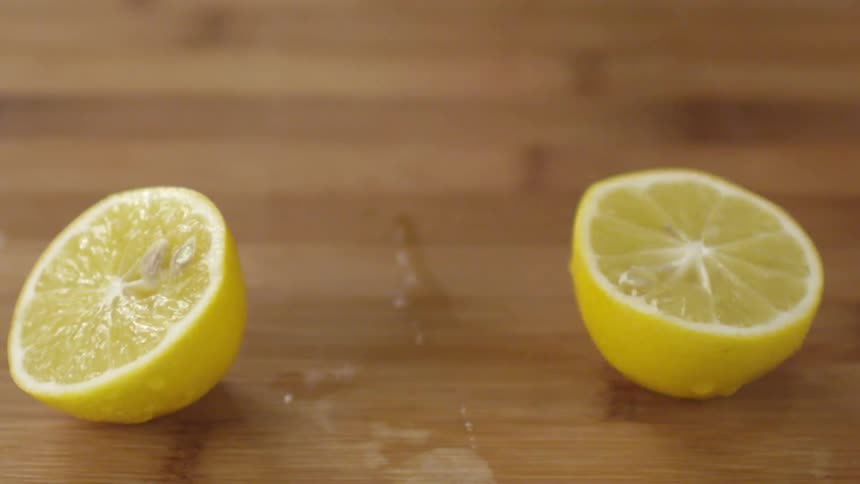 A knife slices a lemon in two