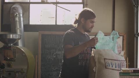 Man opening a large bag in a shop area