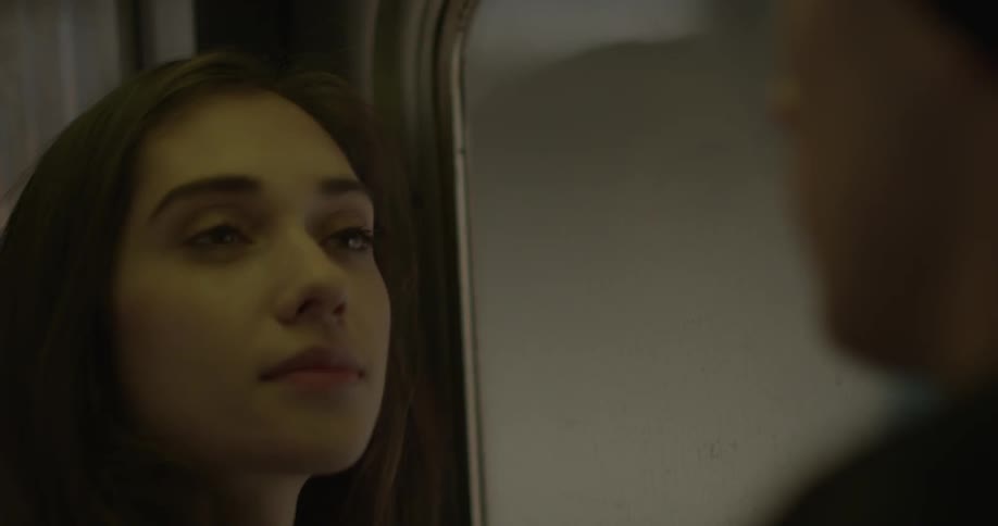 A woman and a man ride a train
