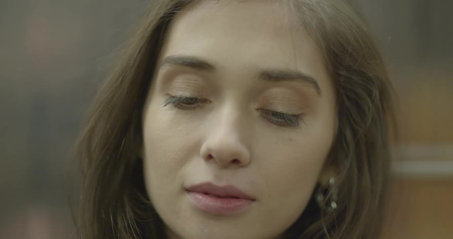 Close up up a young dark haired dark eyed woman