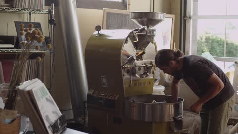 A man makes coffee with a machine