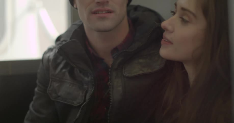 A man and woman talking, then the man nuzzles her and kisses her mouth