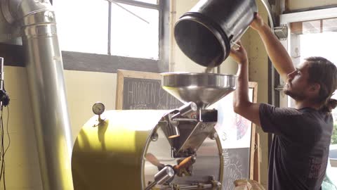 A person pouring stuff into a machine