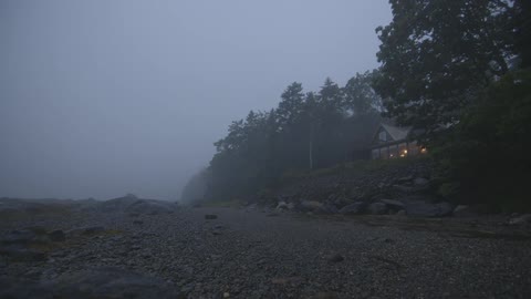 A house is shown on a foggy coastline