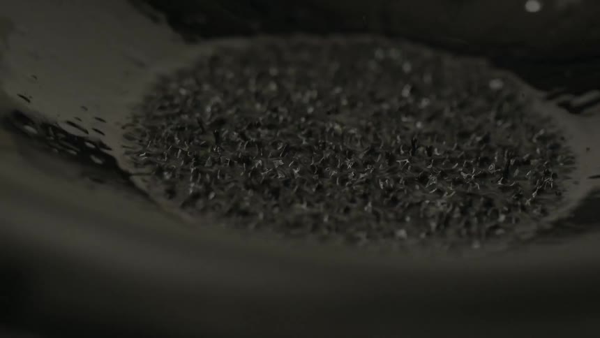 Rain falling into a black container
