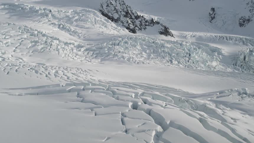 Cracked snow litters the ground