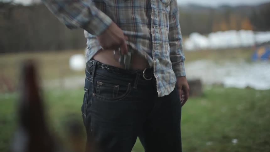 A person with a gun in the pants