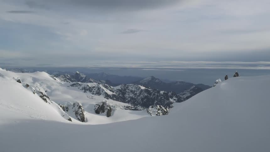 Untouched snow covers the top of the mountains